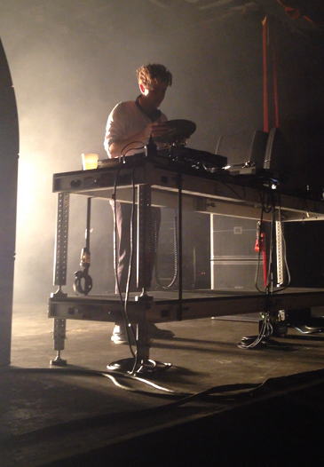 Jamie xx prepares to put a vinyl record on a turntable during his concert at Tempes Marquee Theatre on Wednesday night.