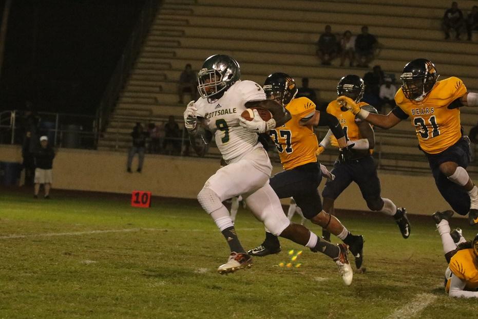 Artichoke wide reciever Shaquan Curenton catches a pass from quarterback Tyler Bruggman and runs for a touchdown during the Artichokes' 59-21 win over Phoenix College in the 2015 season.