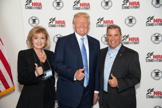 ) Lori Klein and Donald Trump alongside a colleague at the NRA Convention in Nashville, Tennessee. 