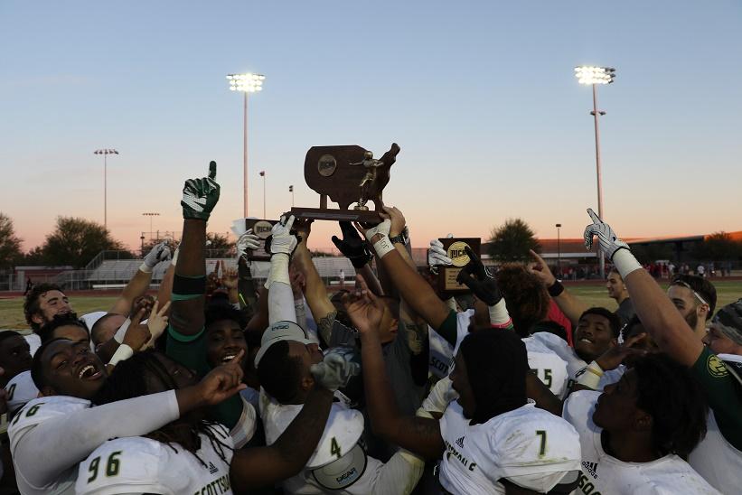 The victorious Artichokes hold up the Valley of the Sun Bowl trophy.