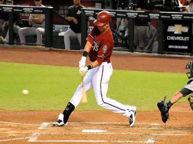 Jake Lamb hits a single to center field during a game against the Oakland As.