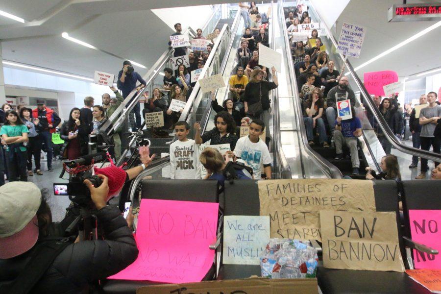 People sitting around escalators on the second day of protests at San Francisco International Airport after the recent Trump Immigration Ban