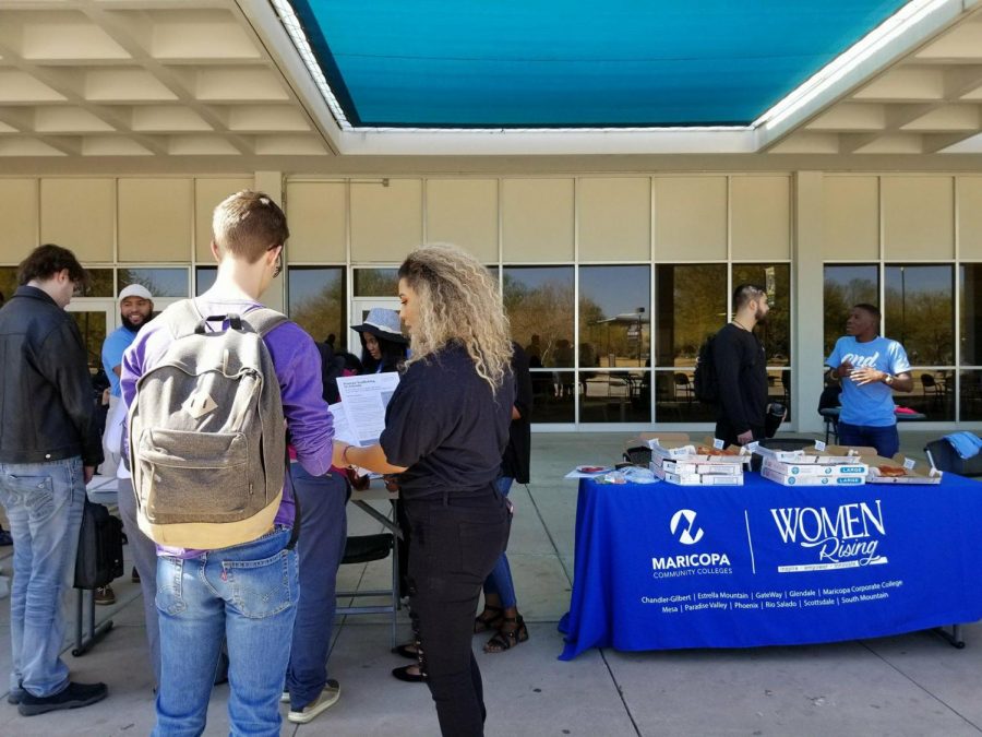 Students gathered around the human trafficking awareness event tables outside of the student center.