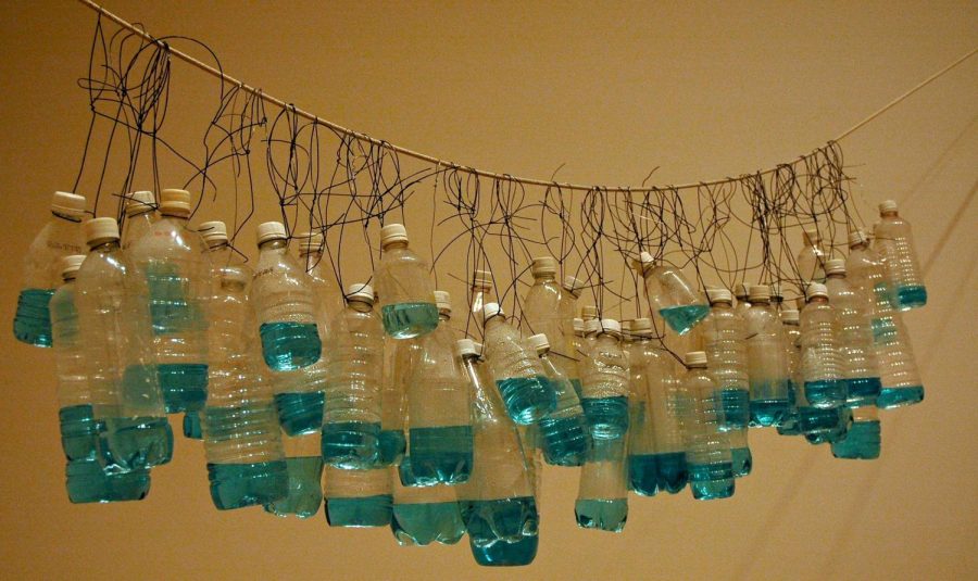 Empty plastic water bottles hung from a wire. 