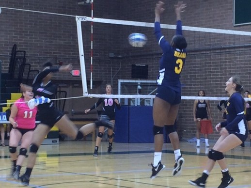 A Phoenix college player leaps for a block during their opening round win in the Scottsdale Classic.