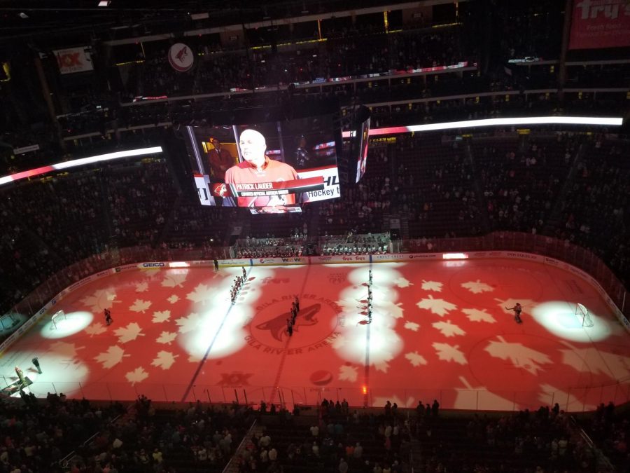 The Coyotes and Canucks wait for the Canadian National Anthem to be sung by official anthem singer Patrick Lauder.