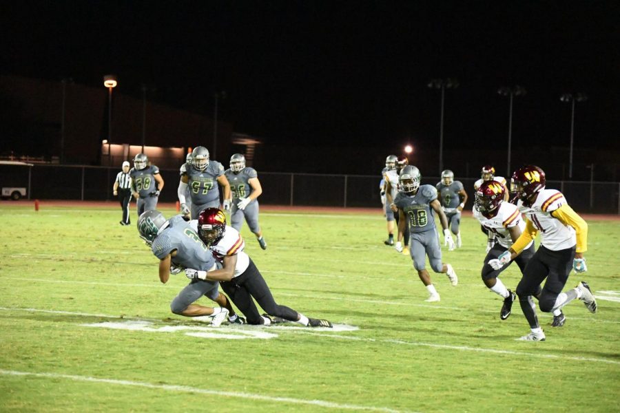 Scottsdale Artichokes Devin Neal with the ball before he is tackled by Arizona Western College 