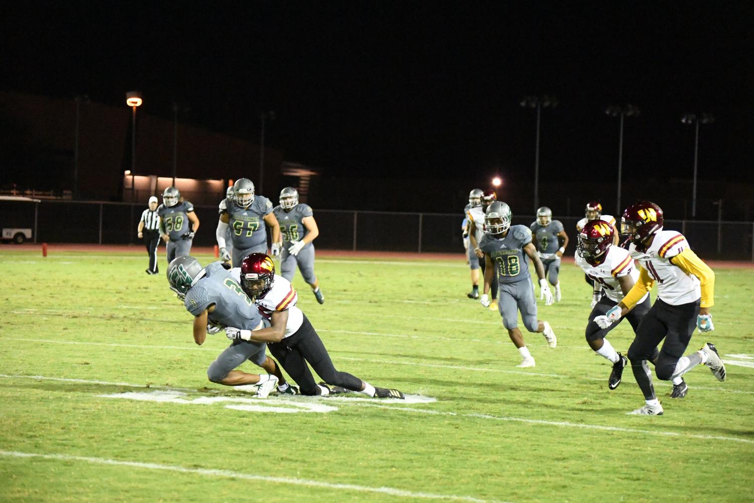Scottsdale Artichokes Devin Neal with the ball before he is tackled by Arizona Western College