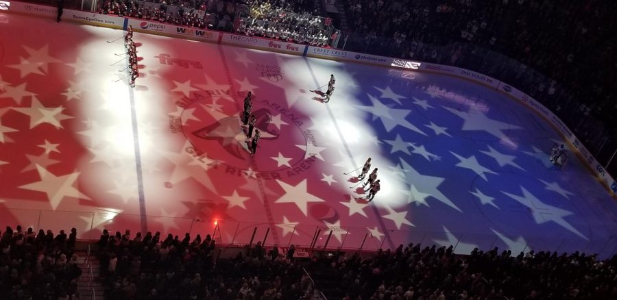 The+Coyotes+and+Golden+Knights+stand+during+the+national+anthem+at+Gila+River+Arena.