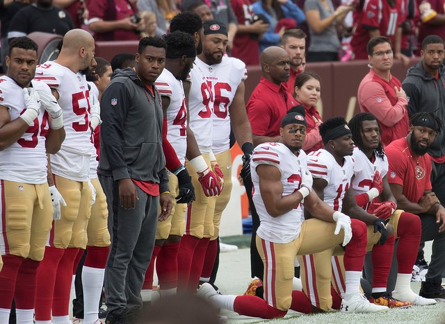 San Francisco 49ers National Anthem Kneeling-Some members of the San Franciso 49ers kneel during the National Anthem before a game against the Washington Redskins at FedEx Field on October 15, 2017 in Landover, Maryland. (Flickr) 