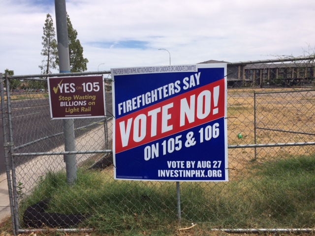 Prop 105 signs along Valley roadway.