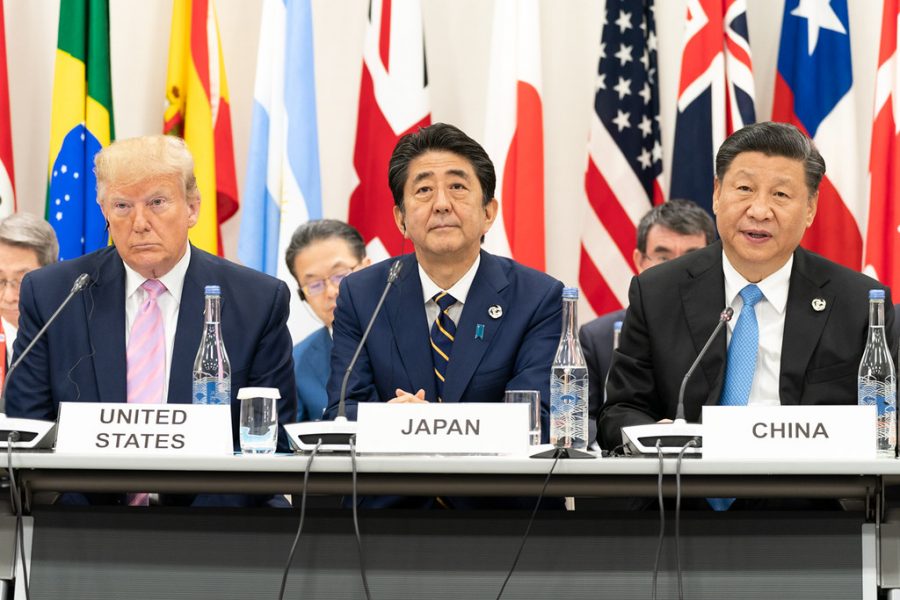 President Donald J. Trump, seated next to Japanese Prime Minister Shinzo Abe, listens as China’s President Xi Jinping, right,