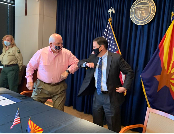 Agriculture Secretary Sonny Perdue and a masked Arizona Governor Doug Ducey