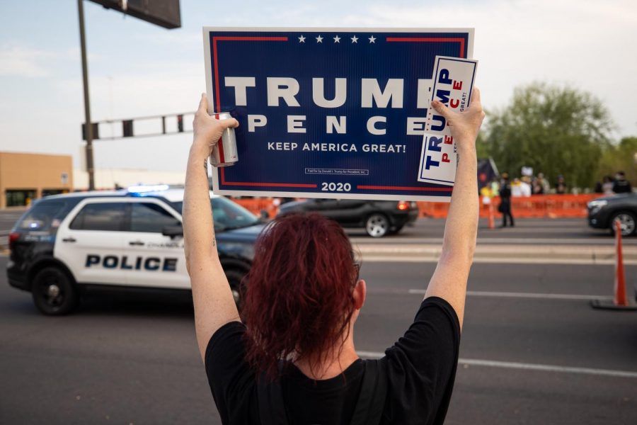 A demonstrator holds Trump-Pence sign during an earlier protest near Phoenix. 