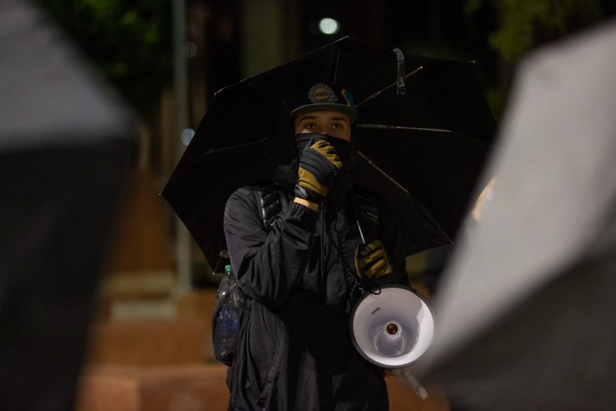 Darien Barrett speaks to the crowd of protesters about the nights plan and why they are gathered.