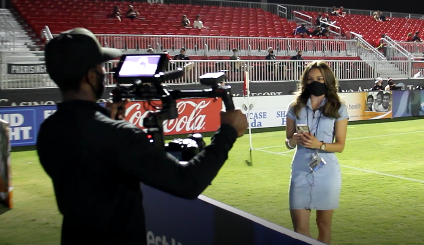 NEVN reporter Cynthia Tapia records a Phoenix Rising game preview with videographer Khiry Shabazz.