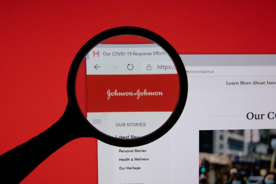 Johnson & Johnson company website page logo on laptop display with red background