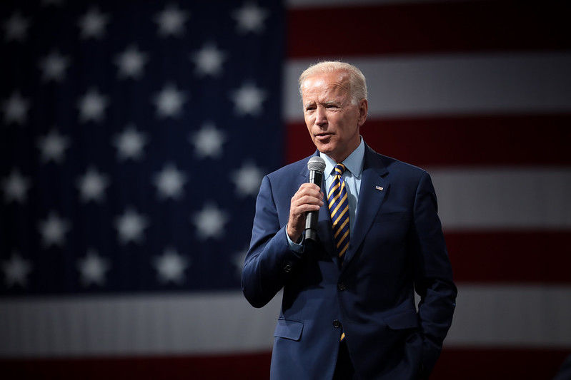 President Joe Biden — pictured here in Iowa — has come under sharp criticism as videos emerged of Border Patrol agents on horseback whipping asylum-seekers from Haiti.