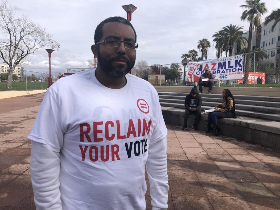 (Paul Underwood) an attendee at the MLK Jr. Celebration Monday, displays message on his shirt regarding concern over voter suppression.
