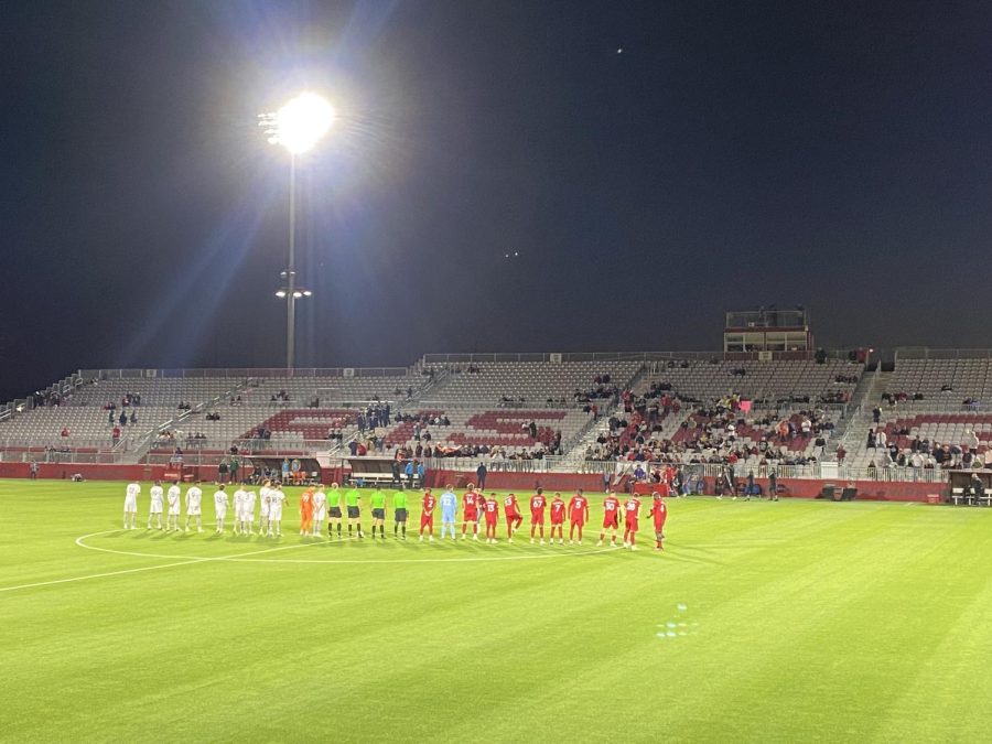 Phoenix Rising and Greenville Triumph stand together on the pitch Wednesday night