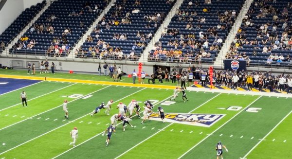 NAU defensive linemen Cory Hall attempts to bring down Lincolns quarterback in the game Saturday.