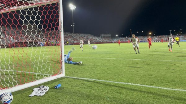 North Carolina Goalie Jake Mcuire dives at a shot.