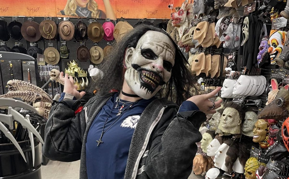 Halloween shopper trying on mask at Spirit Halloween store