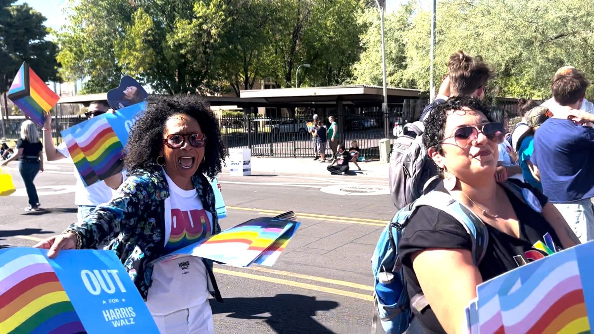 Phoenix Pride attendees wearing "Out for Harris" apparel at Pride parade and celebration.