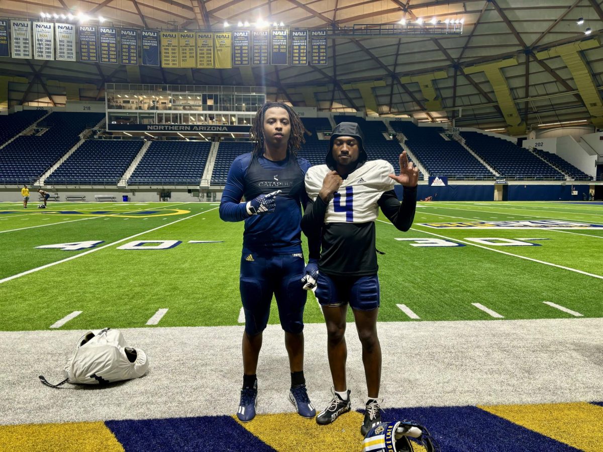 Senior NAU defensive players Christopher Smith (left) and DJ VanHook (right) under Northern Arizona's Skydome