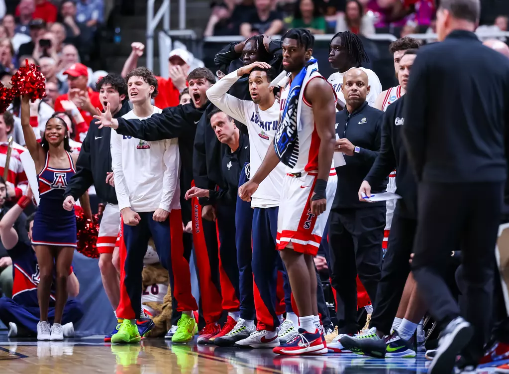 Managers and staff of the U of A bench during an intense moment.
