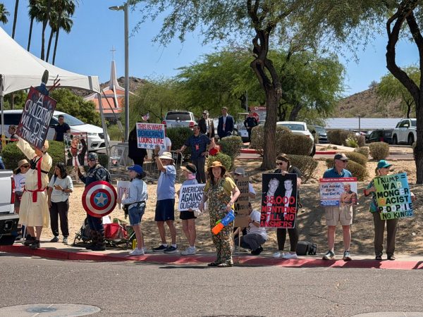 Protestors line public sidewalks near church where Trump was speaking at a Turning Point event, Friday